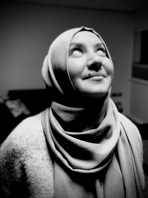 Black-and-white self-portrait of a young woman in a headscarf, from the photography course